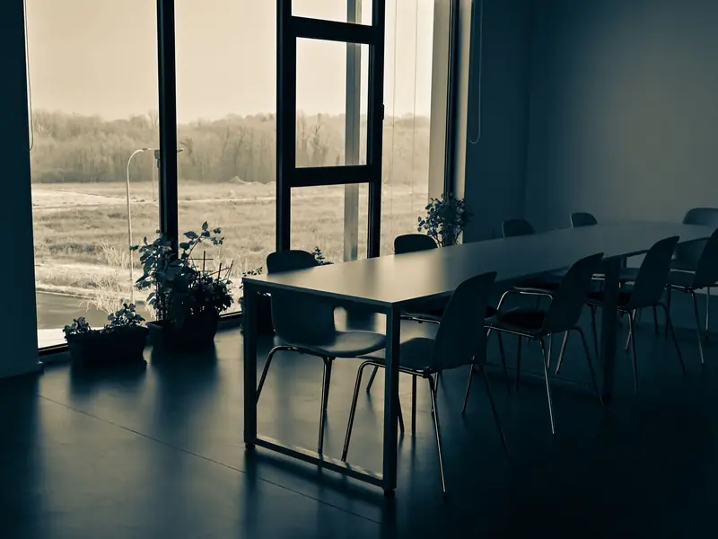 A quiet office meeting table by a window