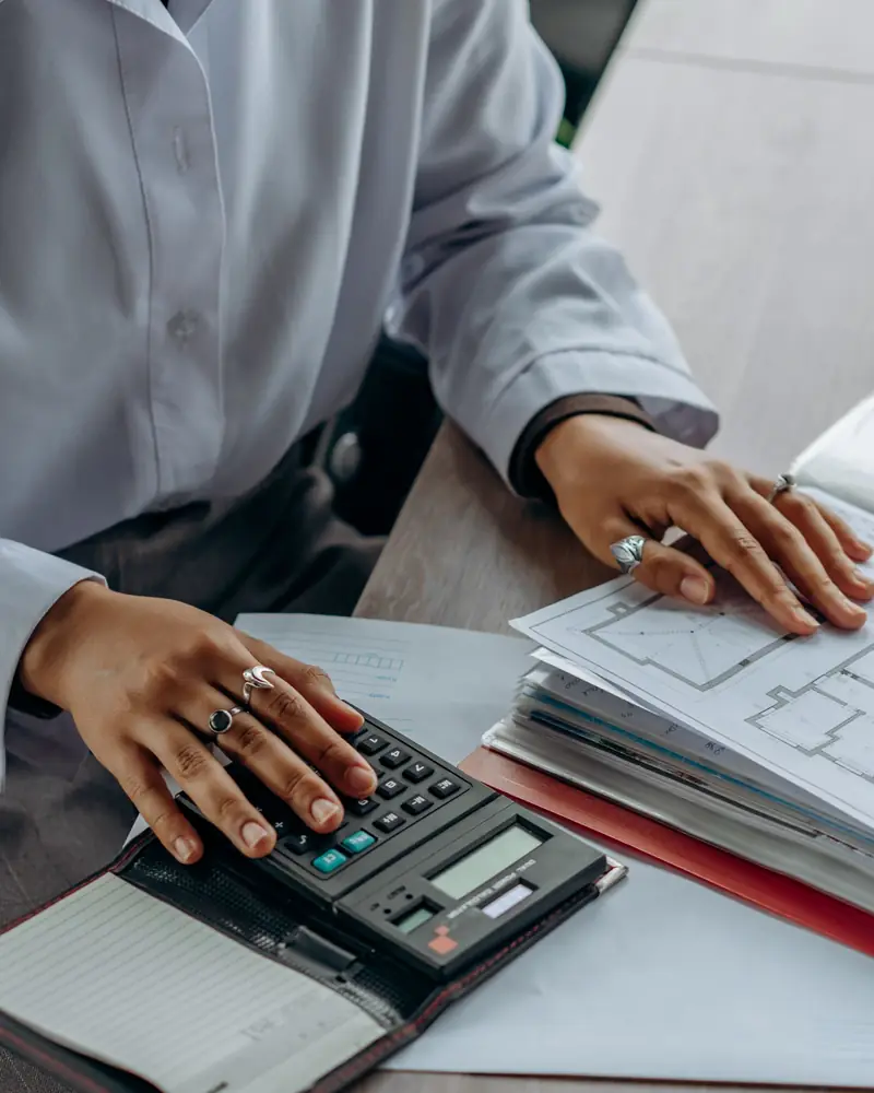 Paper bills and a calculator on a desk