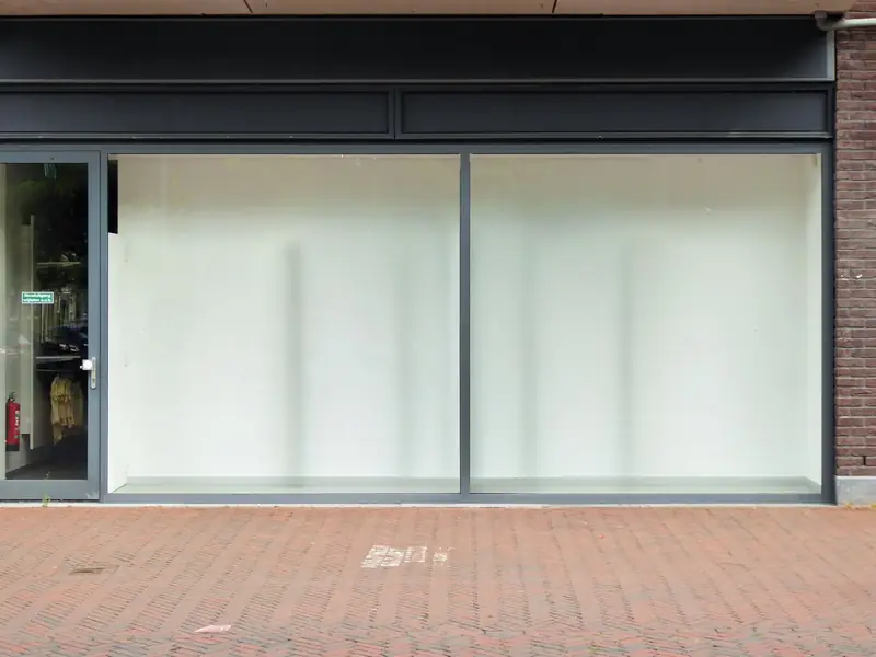 An empty shop unit with large windows, ready for a new tenant